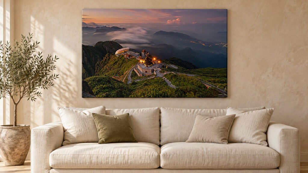 Large landscape canvas print in a slim oak frame above a sofa
